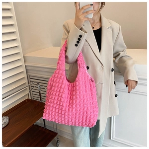 Detailed close-up showing the unique popcorn texture and handle of the pink tote bag