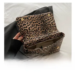 Internal view of the leopard print shoulder bag showing large capacity and magnetic buckle