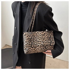 Detail of leopard print chain shoulder bag with textured faux leather and metal strap
