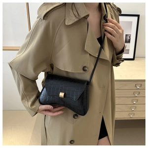 Classic black crocodile pattern shoulder bag with a curved base and gold metal clasp