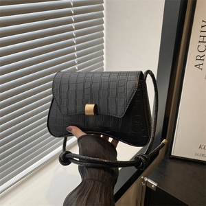 Minimalist black crocodile pattern shoulder bag with a square golden buckle and knotted strap