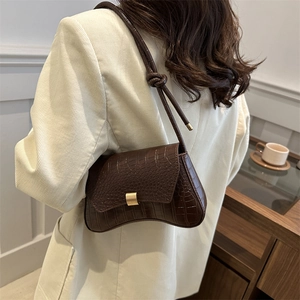 Dark brown faux crocodile skin underarm bag with gold buckle and knotted shoulder strap