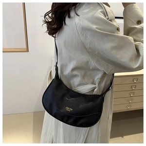 Detail of black pebbled leather crescent crossbody bag with gold JING PIN PIJU lettering