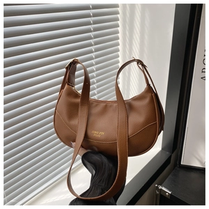 Close-up of brown lychee grain leather crescent hobo bag with gold stamped logo and zipper