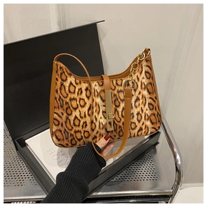 Détail du sac léopard avec boucle en métal doré et poignée en cuir marron élégante