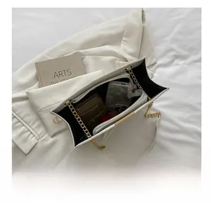 Interior view of white croc-embossed tote bag showing large capacity and chain strap