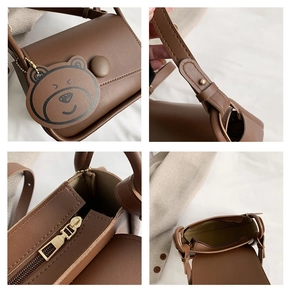 Detailed views of brown faux leather crossbody bag with cute bear charm and metal zipper