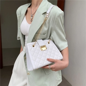 Elegant white quilted shoulder bag with gold chain and metal clasp shown on model