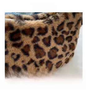 Detailed macro view of soft leopard print faux fur texture and zipper on the bag