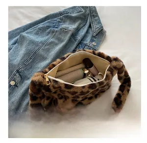 Leopard print plush shoulder bag showing interior capacity with wallet and umbrella