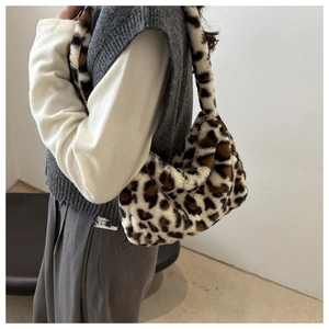 Detail of trendy leopard print plush shoulder bag on model with soft faux fur texture