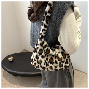 Detail of soft plush shoulder bag featuring classic leopard print and fuzzy texture