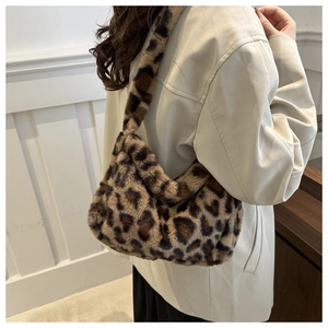 Detail of soft leopard print faux fur shoulder bag with wide integrated strap for winter