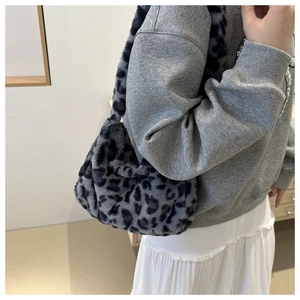 Close-up of leopard print plush shoulder bag styled with a minimalist autumn outfit