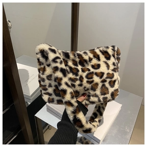 Close-up of fluffy faux fur shoulder bag featuring a stylish leopard print pattern