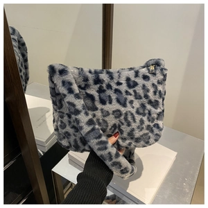 Close-up of leopard print faux fur texture and golden metal zipper on the shoulder bag