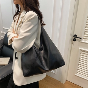 Minimalist large black tote bag for women made of premium synthetic leather in modern style