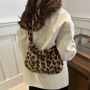 Stylish faux fur leopard print shoulder bag for women shown on a model's shoulder