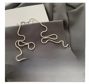 Detailed close-up of a sleek silver metal snake bone chain strap for shoulder bags