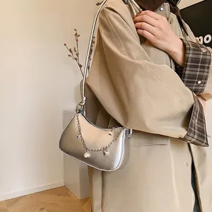 Silver metallic crescent hobo bag with pearl heart chain and minimalist shoulder strap