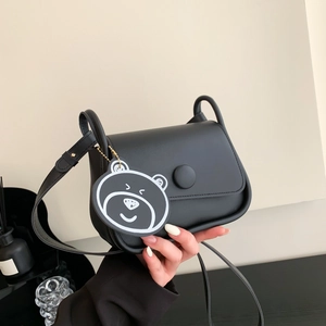 Chic black matte PU leather crossbody bag with a cartoon bear pendant and adjustable strap