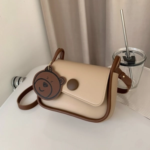 Retro minimalist beige crossbody bag with brown trim and cute bear pendant charm