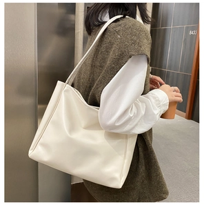 Minimalist white PU leather tote bag shown on shoulder for daily commute style