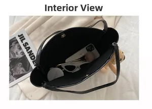 Macro shot showing the spacious black leather tote interior with magnetic clasp