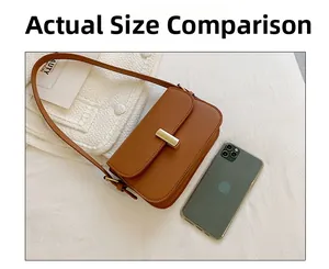 Brown rectangular leather shoulder bag shown next to a smartphone for size comparison
