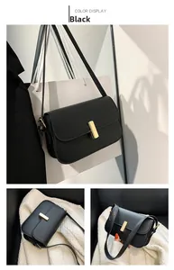 Detail of matte black crossbody bag with gold vertical clasp and adjustable strap