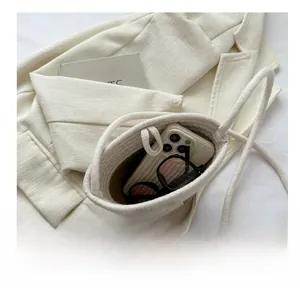 Detail view of woven bucket bag interior showing capacity for phone and sunglasses