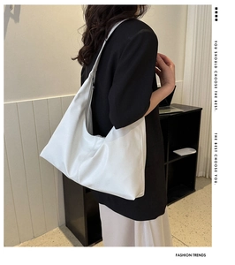 White minimalist leather hobo bag for women shown on a model for daily commuting