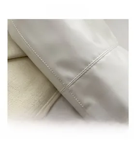 Detailed close-up of white leather texture and premium double stitching on the tote bag