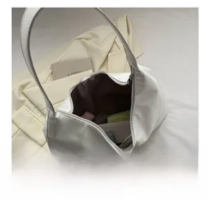 Spacious interior view of the white shoulder tote bag with various daily essentials