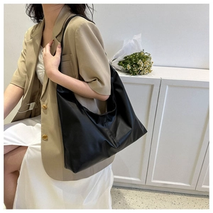 Detail shot of a black hobo shoulder bag showing premium leather texture and moon shape