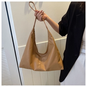 Detail of soft brown PU leather shoulder bag with fine stitching and large capacity