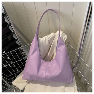 Detail of lavender PU leather shoulder bag with glossy finish and center seam detail