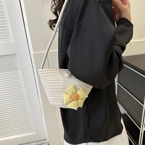 Chic woven straw bucket bag with plaid flower and pearl detail for beach and daily commute