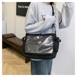 Detail of black canvas messenger bag with large transparent PVC display window