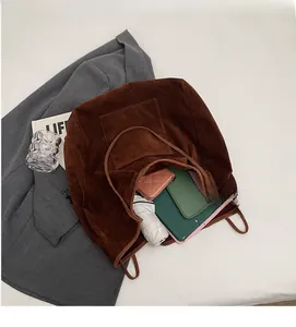 Top view of spacious interior of dark brown matte tote bag with daily essentials