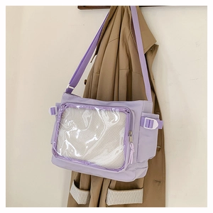 Detail view of light purple crossbody bag featuring a transparent PVC display window