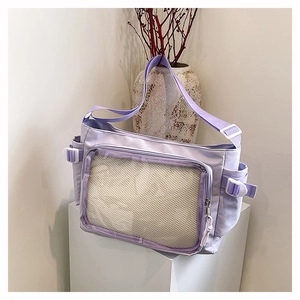 Macro detail of lavender nylon crossbody bag with transparent mesh pocket and side buckles