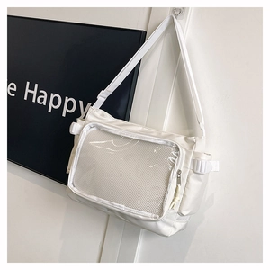 Detail of white messenger bag featuring a transparent PVC window and adjustable strap