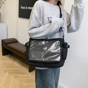 Minimalist black canvas tote bag with transparent PVC display window and adjustable strap