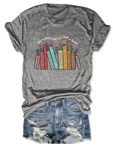 Flat lay of gray cotton t-shirt with books and flower print paired with denim shorts