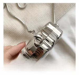 Close-up of premium metal hook and textured silver surface on a stylish evening bag
