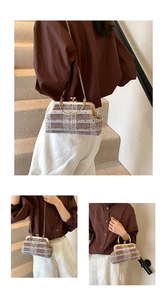 Close-up of vintage plaid shell bag with golden arched handle and slim metal chain detail