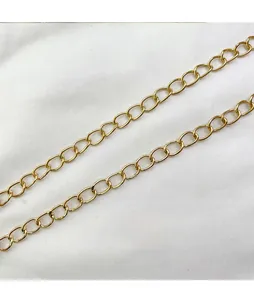 Detail of elegant gold metal chain strap with ring links on white fabric background