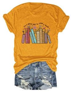 Detail of a mustard yellow t-shirt with book floral print and distressed denim shorts