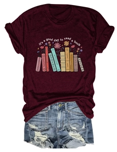 Detail of burgundy T-shirt with book and floral print paired with denim shorts